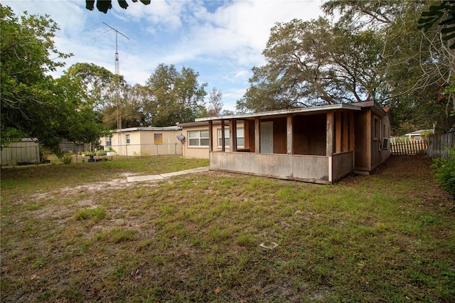 rear view of house with a lawn