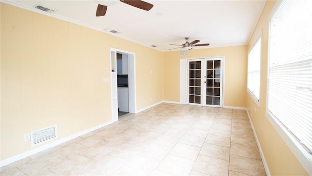 tiled empty room featuring ceiling fan