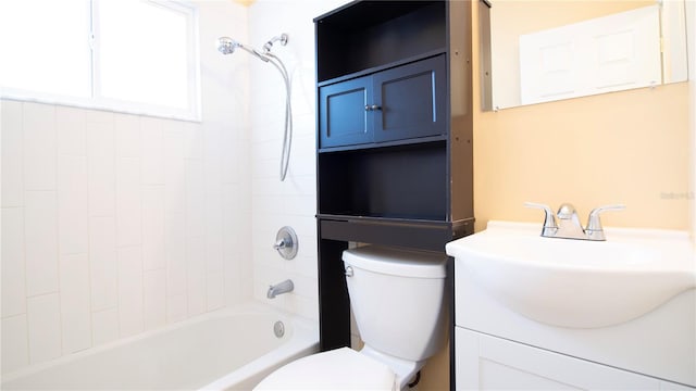 full bathroom with vanity, tiled shower / bath combo, and toilet