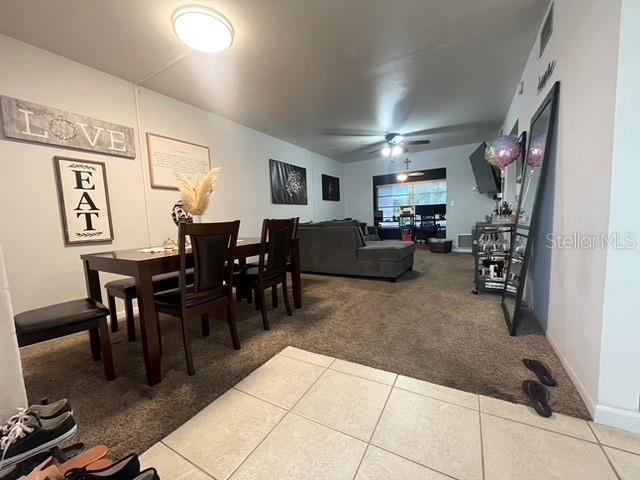 dining area with carpet floors and ceiling fan