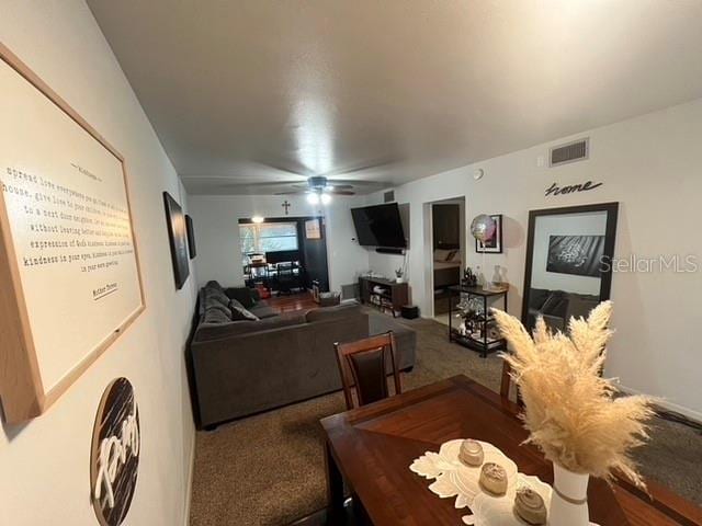 carpeted living room featuring ceiling fan