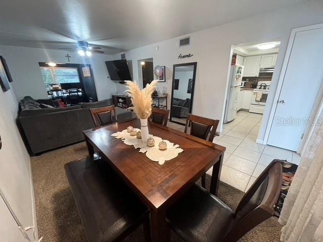 dining area with light tile patterned floors and ceiling fan