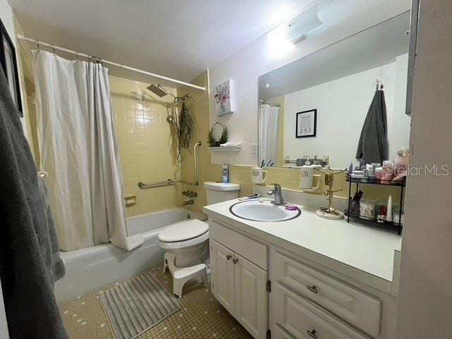 full bathroom featuring shower / tub combo with curtain, tile patterned floors, toilet, and vanity