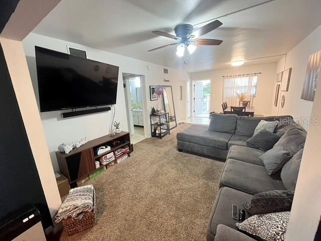 living room featuring carpet flooring and ceiling fan