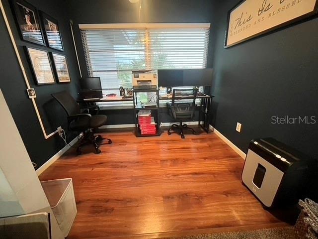 home office with wood-type flooring