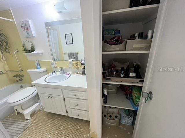 full bathroom featuring tile patterned flooring, vanity, shower / tub combo, and toilet