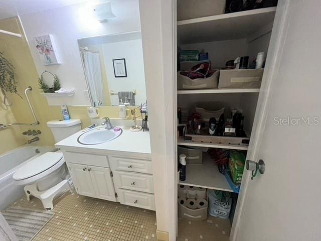 bathroom with toilet, shower / bath combo, vanity, and tile patterned floors