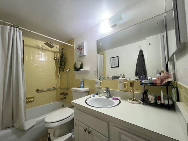 bathroom with toilet, shower / bath combo, and vanity