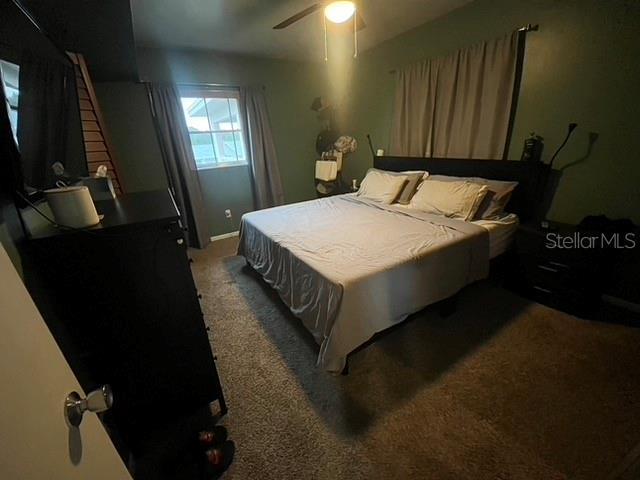 carpeted bedroom featuring ceiling fan