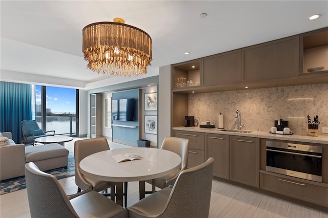 dining space with a notable chandelier and sink