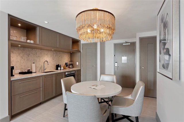 dining room featuring sink and an inviting chandelier