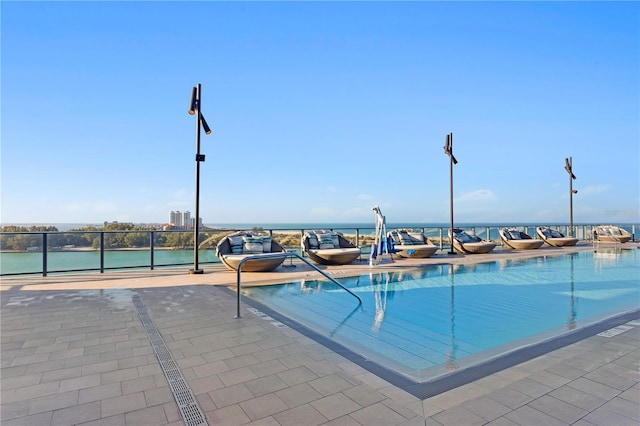 view of swimming pool featuring a water view