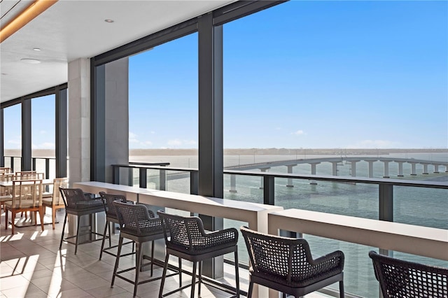 balcony with a water view and an outdoor bar