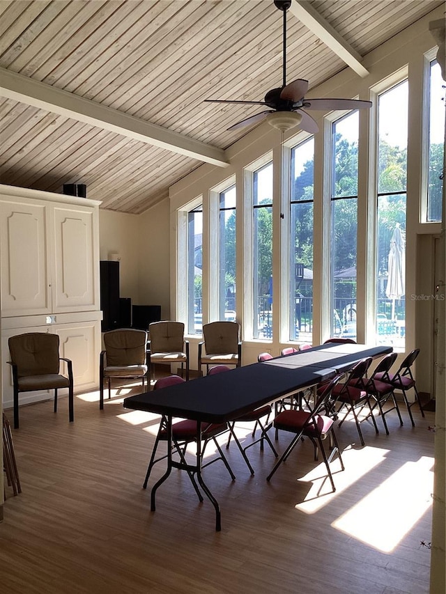 sunroom / solarium featuring vaulted ceiling with beams and ceiling fan