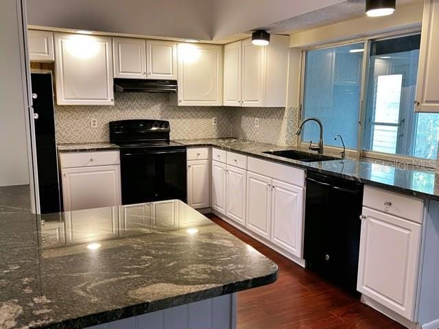 kitchen with dark hardwood / wood-style flooring, sink, black appliances, and white cabinets