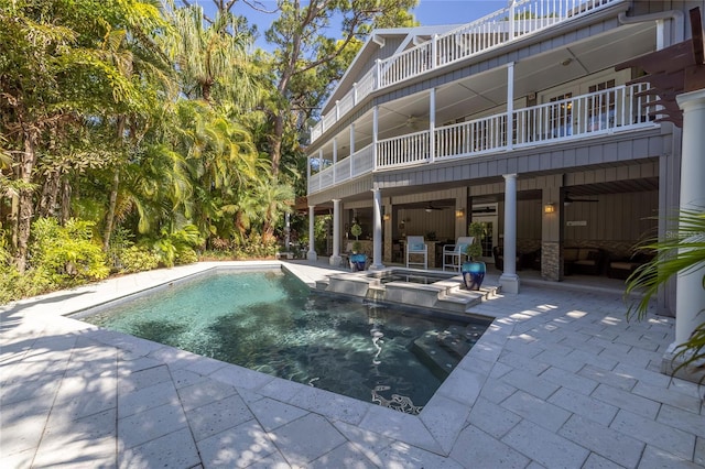 view of pool with a patio area and an in ground hot tub