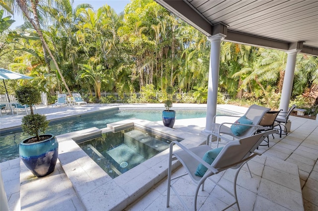 view of swimming pool with a patio area and an in ground hot tub