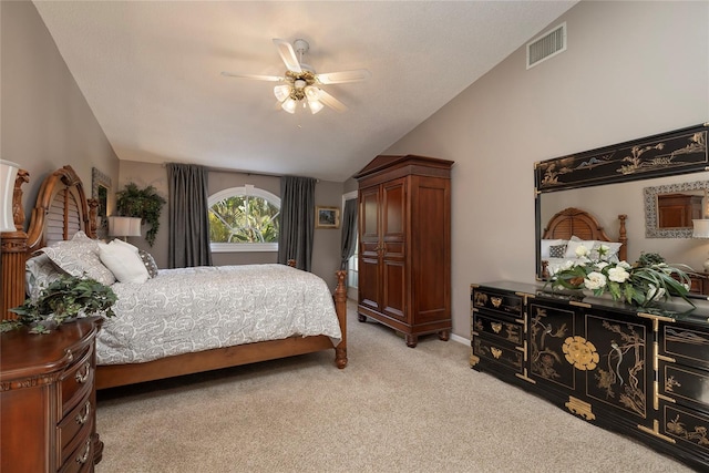 carpeted bedroom with ceiling fan and vaulted ceiling