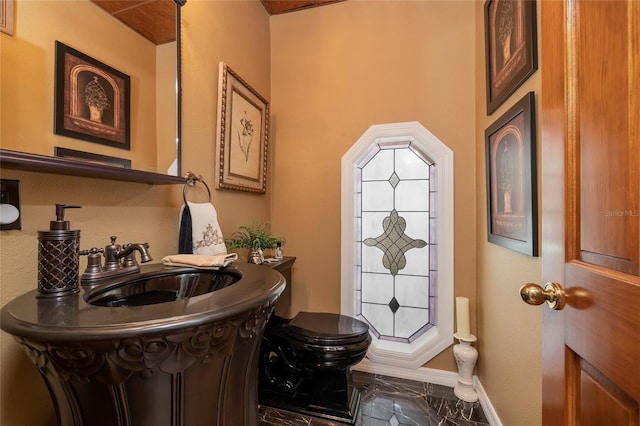 bathroom with sink, toilet, and tile floors