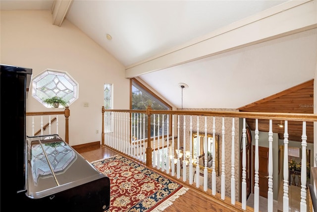 corridor featuring an inviting chandelier, lofted ceiling with beams, and dark hardwood / wood-style floors