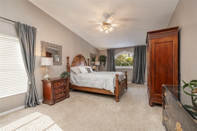 carpeted bedroom featuring ceiling fan and vaulted ceiling