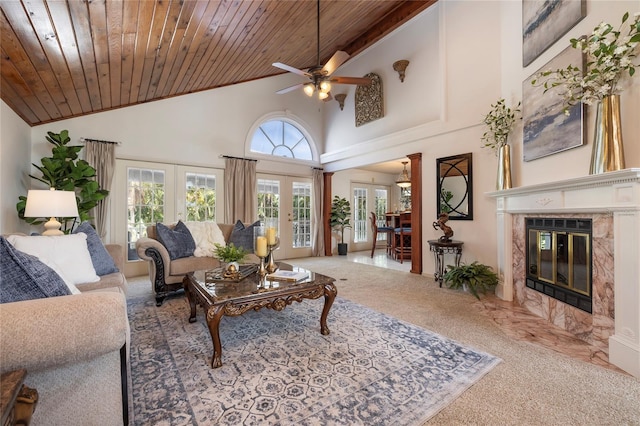 761 Soundview Dr, Palm Harbor, FL 34683 - living room with a ceiling fan, carpet flooring, a premium fireplace, french doors, and high vaulted ceiling