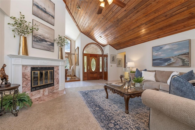 761 Soundview Dr, Palm Harbor, FL 34683 - living room featuring wood ceiling, ceiling fan, carpet floors, high vaulted ceiling, and a high end fireplace