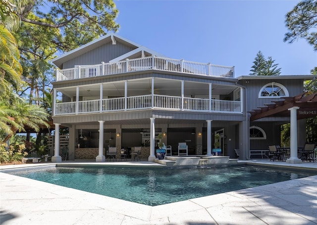 761 Soundview Dr, Palm Harbor, FL 34683 - rear view of property featuring a balcony, a patio area, and an outdoor pool