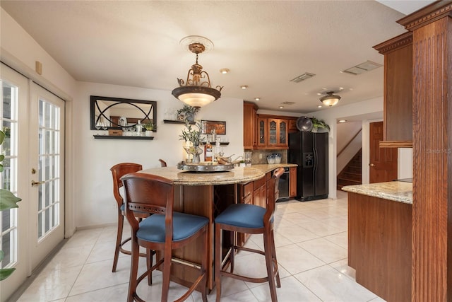 761 Soundview Dr, Palm Harbor, FL 34683 - dining room featuring bar with sink, stairs, light tile patterned floors, and french doors