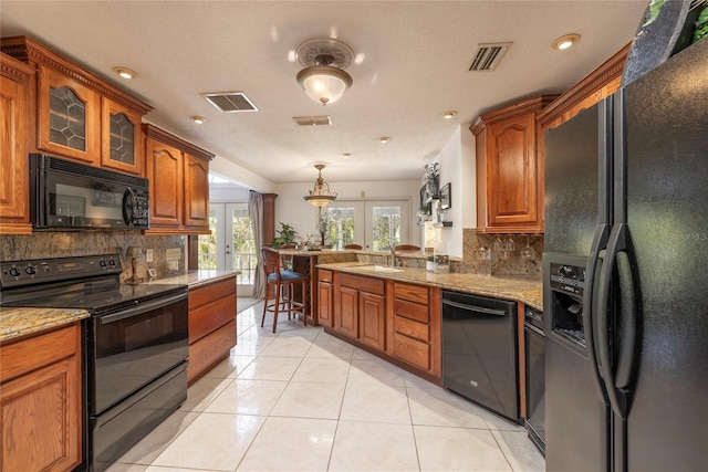761 Soundview Dr, Palm Harbor, FL 34683 - kitchen featuring black appliances, french doors, tasteful backsplash, a sink, and recessed lighting