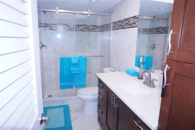 bathroom featuring vanity, toilet, and a shower with shower door