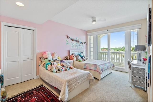 carpeted bedroom with ceiling fan, access to outside, and a closet