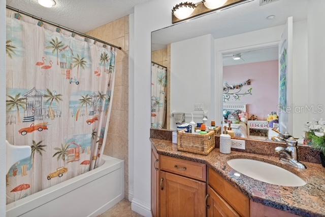 bathroom with vanity and shower / bath combo