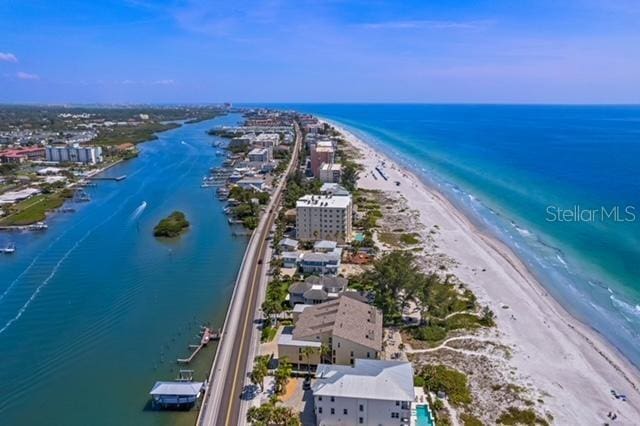 birds eye view of property featuring a beach view and a water view