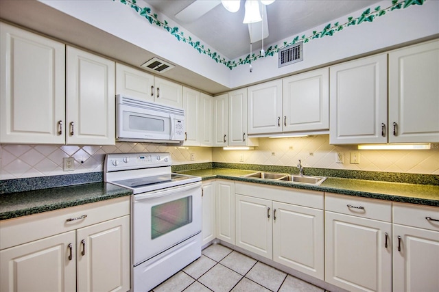 kitchen with white appliances, ceiling fan, sink, light tile patterned floors, and white cabinets