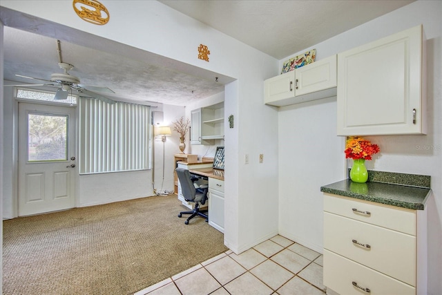 kitchen featuring ceiling fan, white cabinets, and light tile patterned floors