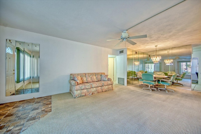 carpeted living room with ceiling fan