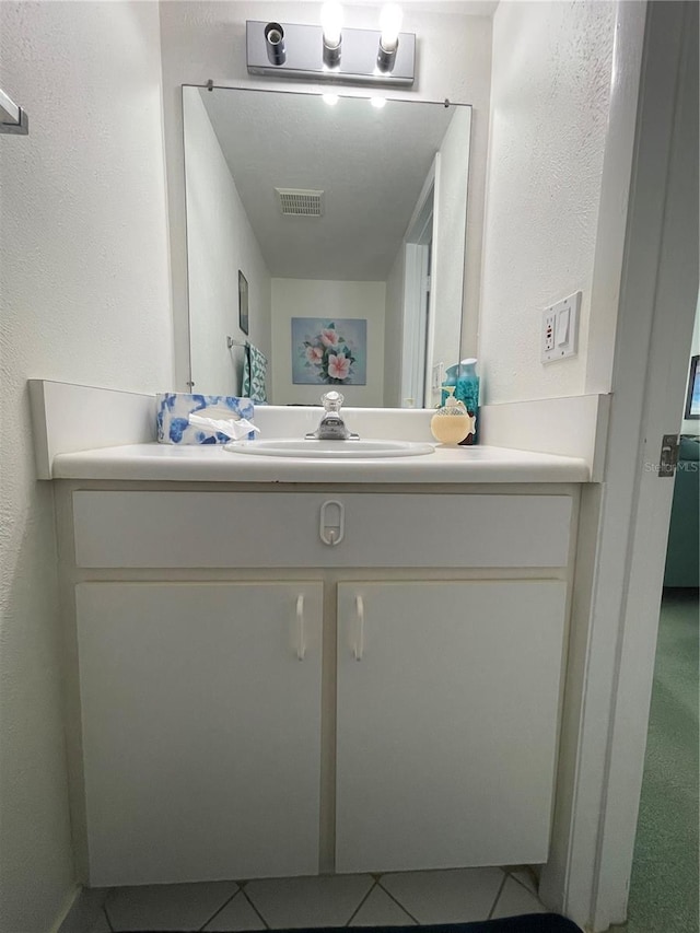 bathroom with tile patterned floors and vanity