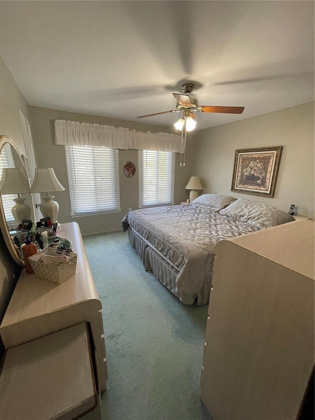 bedroom with ceiling fan and carpet flooring