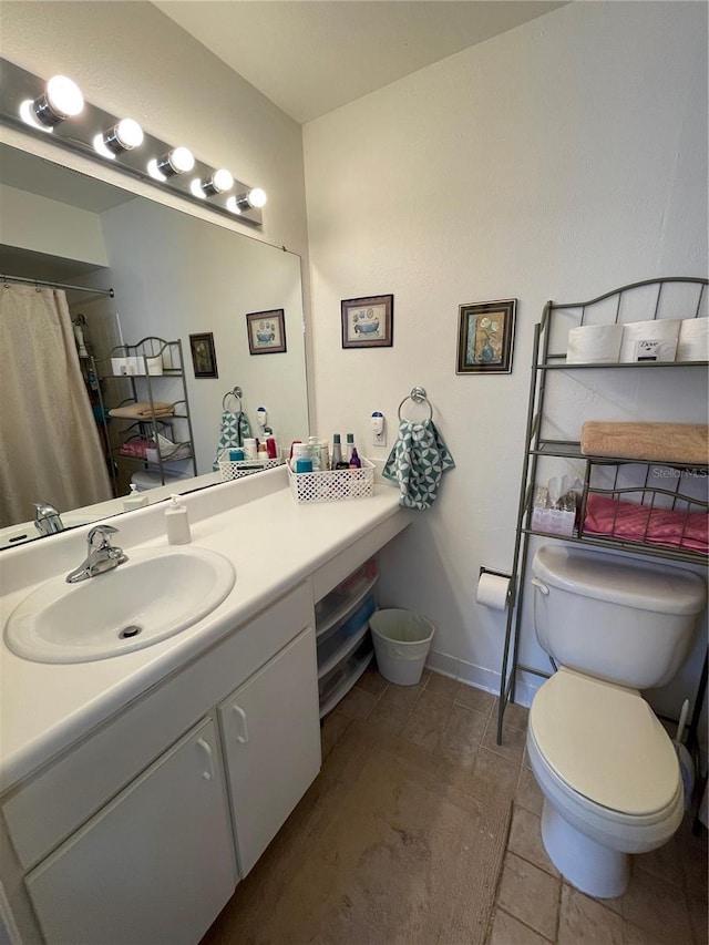 bathroom featuring toilet and vanity