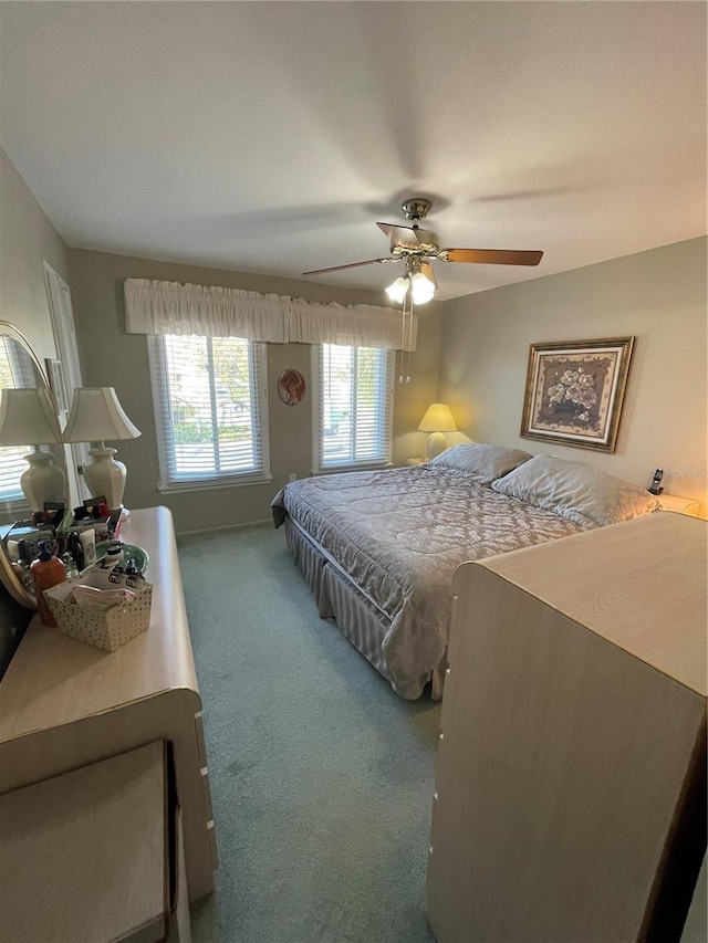 bedroom featuring ceiling fan and carpet