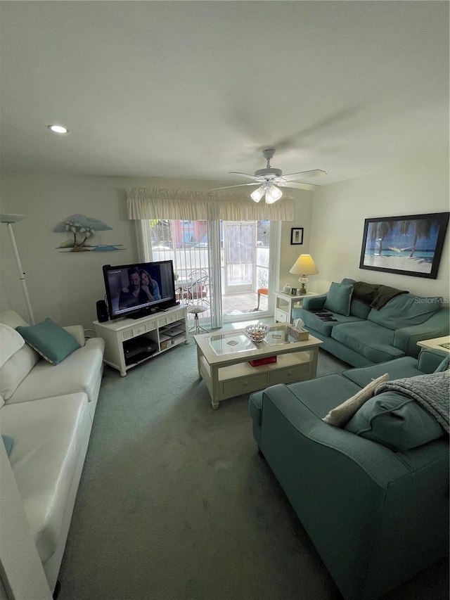 carpeted living room with ceiling fan