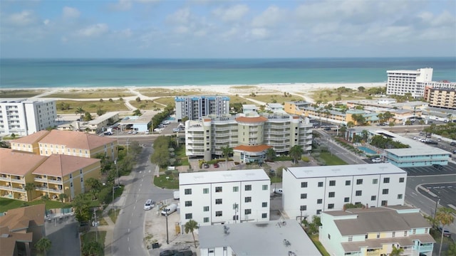 birds eye view of property with a water view and a view of the beach