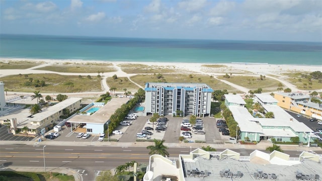 drone / aerial view featuring a water view and a view of the beach