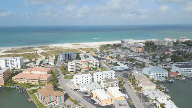 birds eye view of property featuring a water view and a beach view