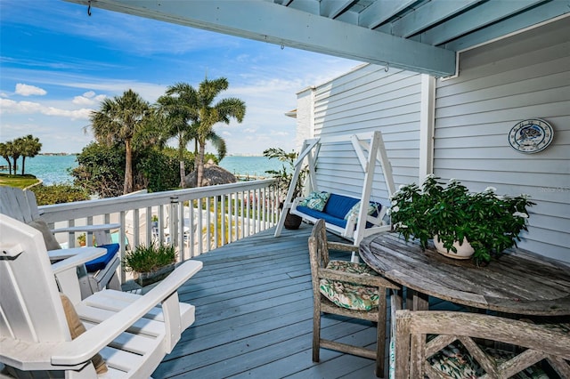 wooden deck featuring a water view