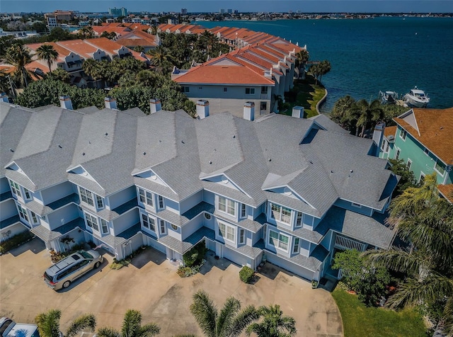 drone / aerial view featuring a water view and a residential view