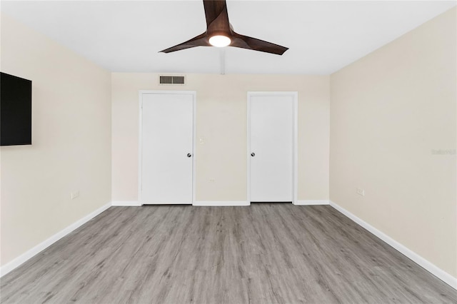 unfurnished bedroom with ceiling fan and light hardwood / wood-style flooring