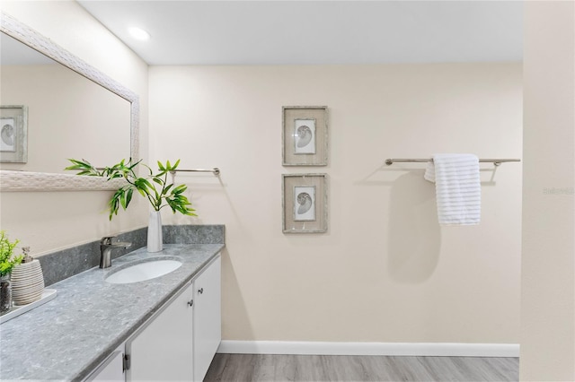 bathroom with vanity and hardwood / wood-style flooring