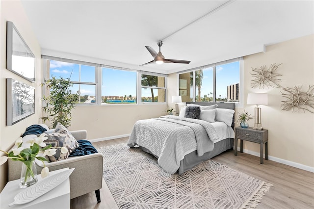 bedroom with light wood-type flooring and ceiling fan